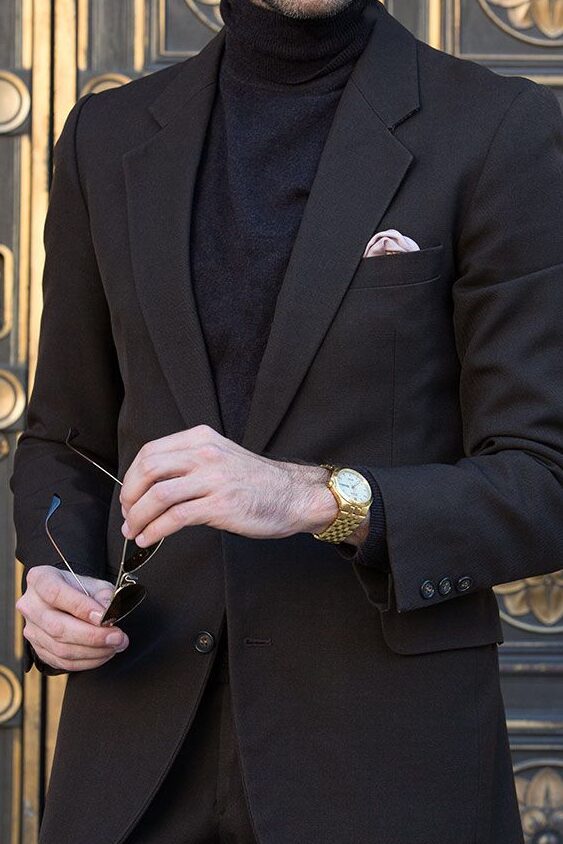 Man wearing black turtleneck with black blazer